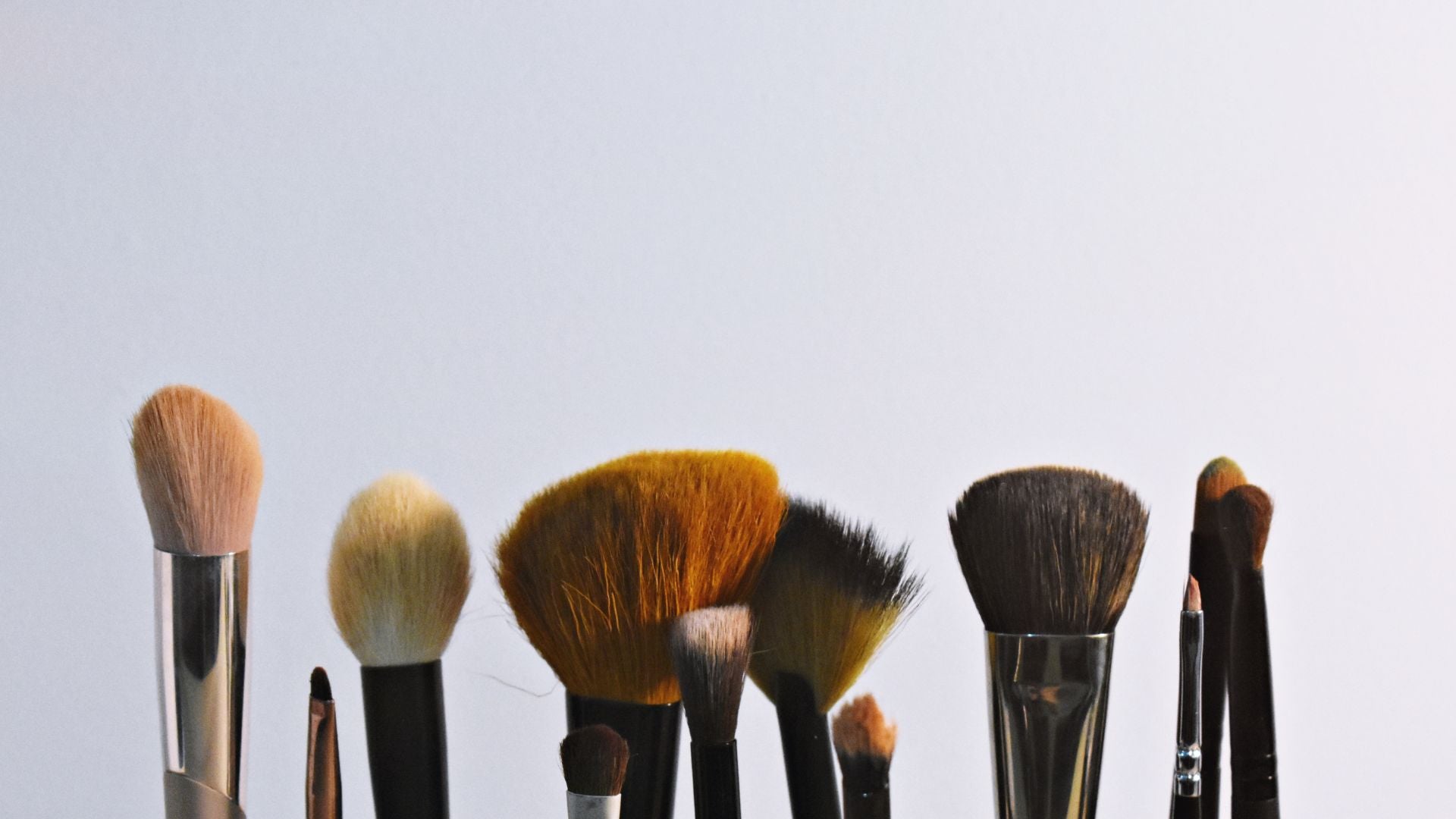 Set of makeup brushes with a neutral background
